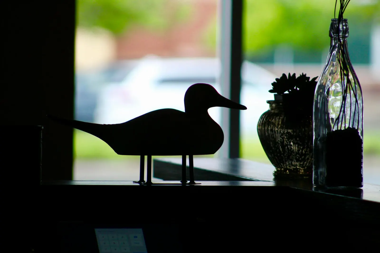 A duck silhouette sculpture in the restaurant window